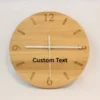 Handmade oak clock engraved with numbers 12, 3, 6, and 9, with line markers for other hours. Shown with white clock hands.