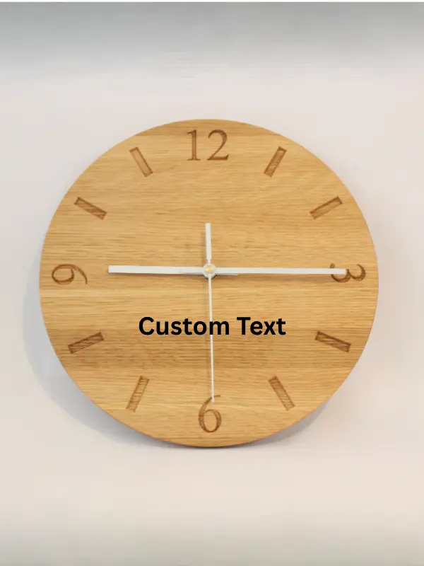 Handmade oak clock engraved with numbers 12, 3, 6, and 9, with line markers for other hours. Shown with white clock hands.