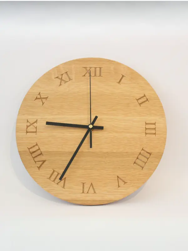 Handmade oak clock engraved with Roman numerals I to XII, A personalised wooden wall clock with optional engraving for names, dates, messages, or logos.