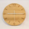 Handmade oak clock engraved with numbers 12, 3, 6, and 9, with line markers for other hours. Shown with white clock hands.